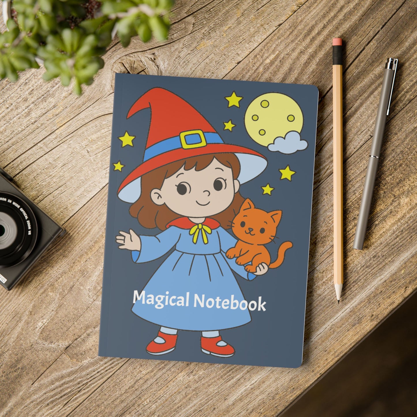 Notebook with a cartoon character on a wooden surface with a pencil and pen.