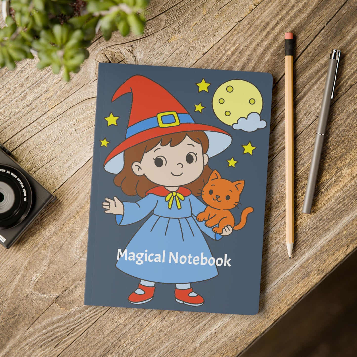 Notebook with a cartoon character and cat on the cover, placed on a wooden surface with stationery items.