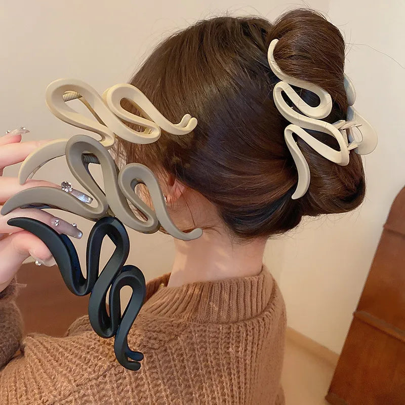 Woman with hair styled using decorative hair clips on a neutral background