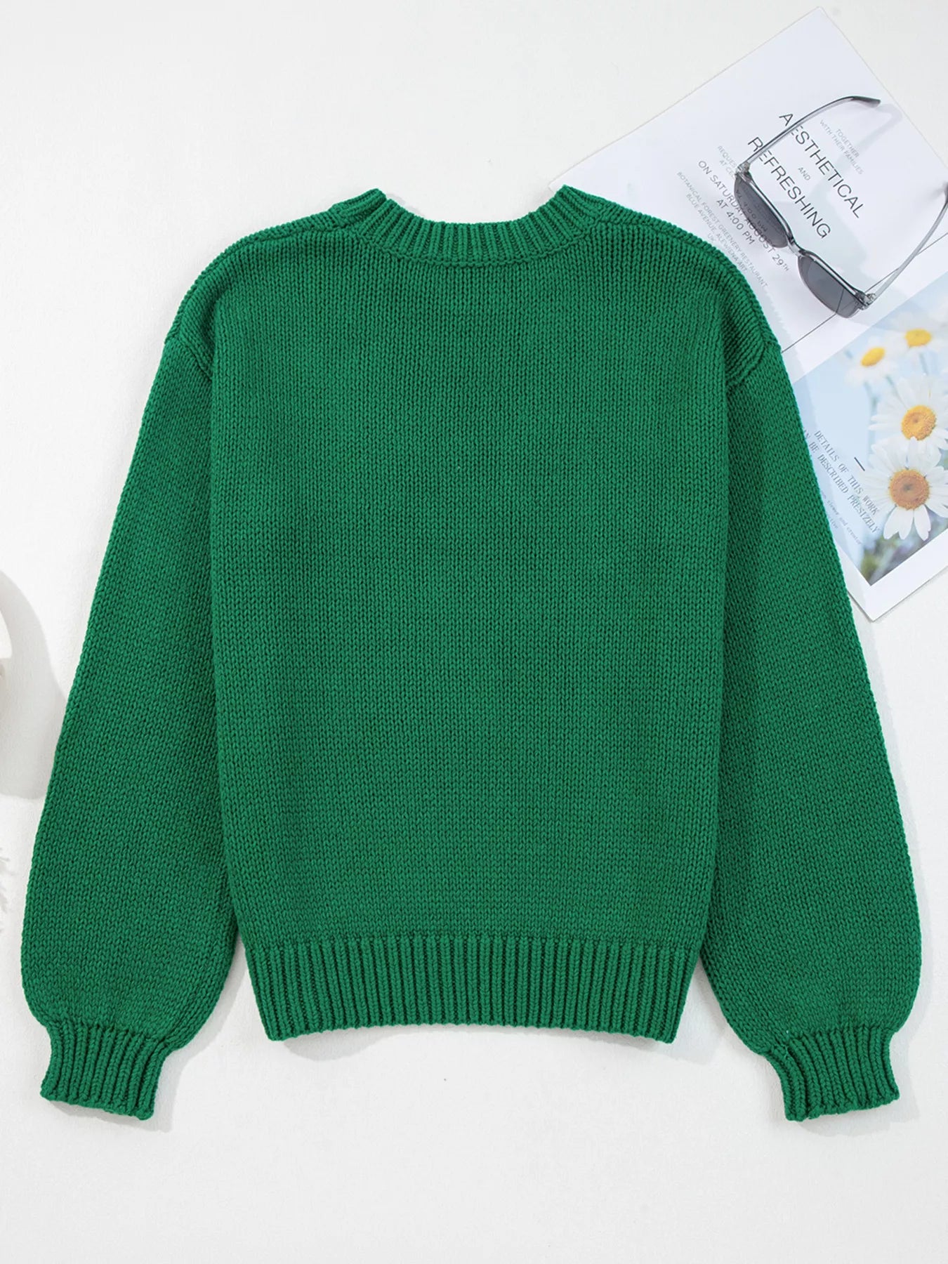 Green sweater on a white background