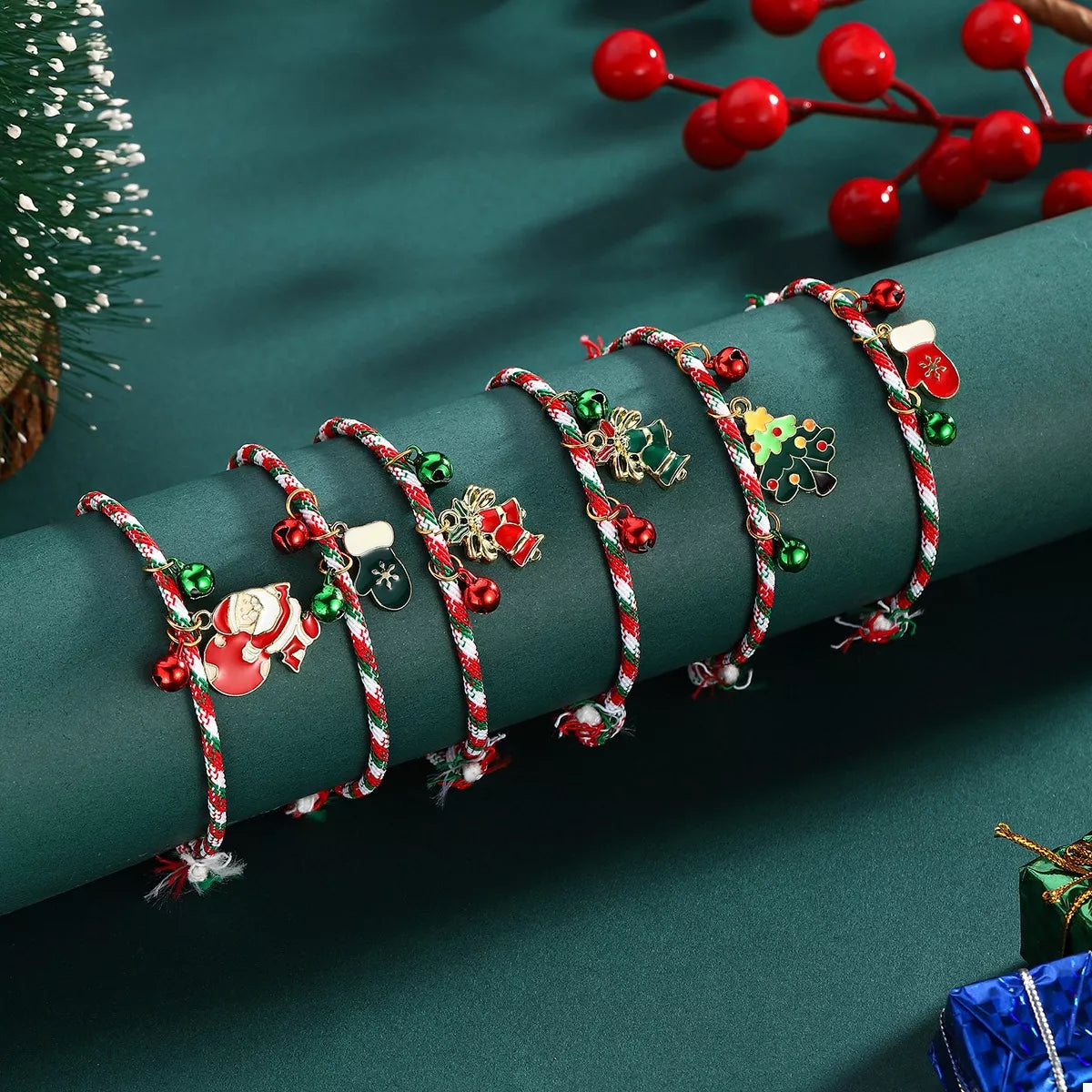 Set of Christmas-themed bracelets on a green surface with decorative elements.