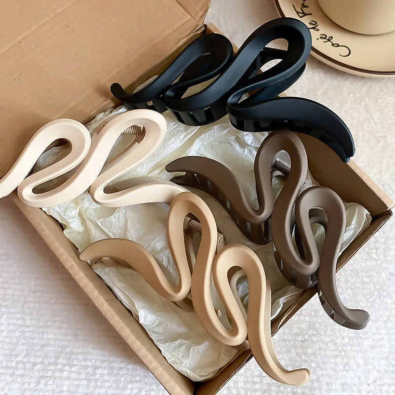 Set of decorative wall hooks in various colors displayed in a box.