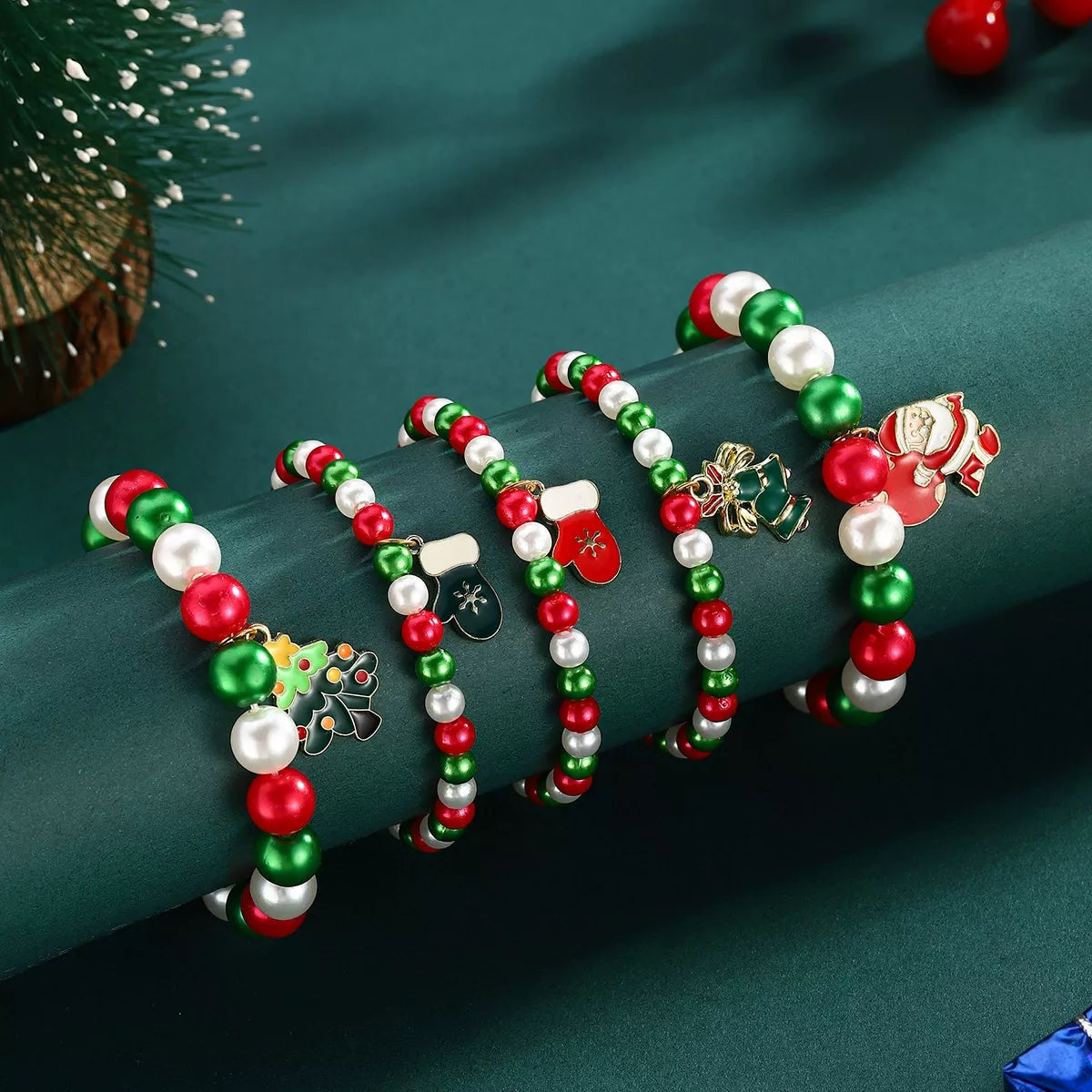 Set of colorful beaded bracelets with decorative charms on a green surface